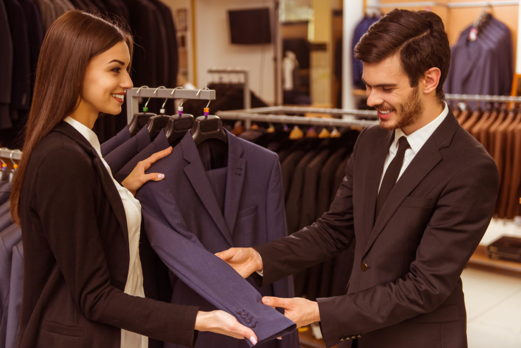 image consultant looking over suit with male client